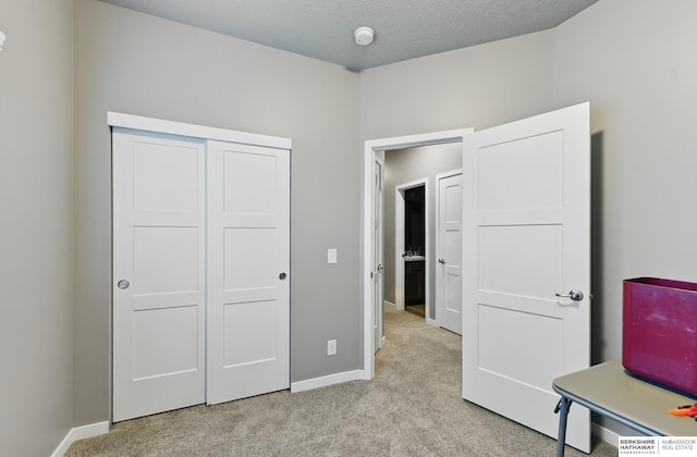 11745 S 113th St, Papillion, NE 68046 - unfurnished bedroom featuring light carpet, baseboards, and a closet