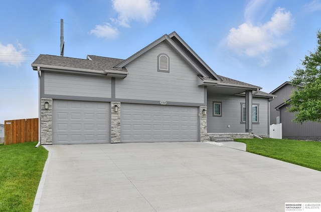 11745 S 113th St, Papillion, NE 68046 - view of front facade featuring driveway, a garage, and stone siding