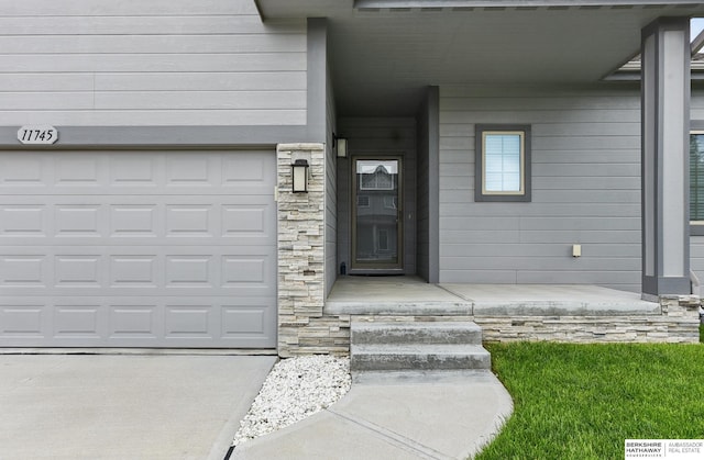 11745 S 113th St, Papillion, NE 68046 - view of exterior entry with stone siding and a garage