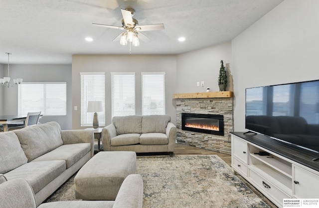 11745 S 113th St, Papillion, NE 68046 - living area with a chandelier, a fireplace, ceiling fan, wood finished floors, and recessed lighting