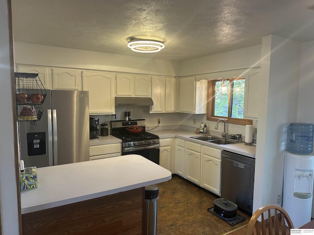 1745 Independence Cir, Lincoln, NE 68521 - kitchen with appliances with stainless steel finishes, under cabinet range hood, a sink, a textured ceiling, and white cabinets