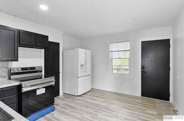 2544 N 64th St, Omaha, NE 68104 - kitchen featuring white fridge with ice dispenser, electric range, dark cabinetry, light wood-style flooring, and light countertops