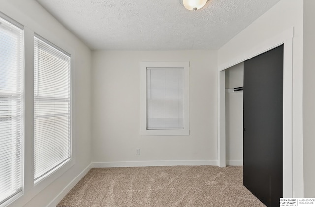 2544 N 64th St, Omaha, NE 68104 - unfurnished bedroom featuring light colored carpet, a closet, a textured ceiling, and baseboards