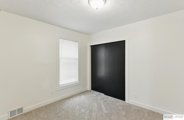 2544 N 64th St, Omaha, NE 68104 - unfurnished bedroom with carpet, baseboards, and a textured ceiling