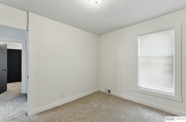 2544 N 64th St, Omaha, NE 68104 - spare room with light colored carpet, baseboards, and a textured ceiling