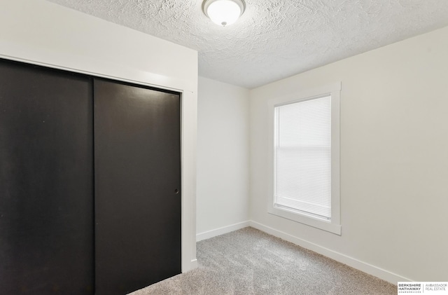 2544 N 64th St, Omaha, NE 68104 - unfurnished bedroom with carpet, a closet, baseboards, and a textured ceiling
