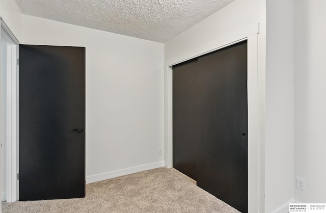 2544 N 64th St, Omaha, NE 68104 - unfurnished bedroom featuring carpet flooring, a textured ceiling, a closet, and baseboards