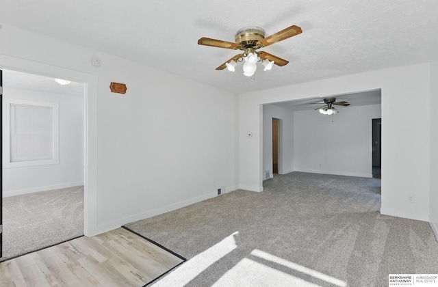 2544 N 64th St, Omaha, NE 68104 - carpeted empty room featuring a ceiling fan, baseboards, wood finished floors, and a smoke detector