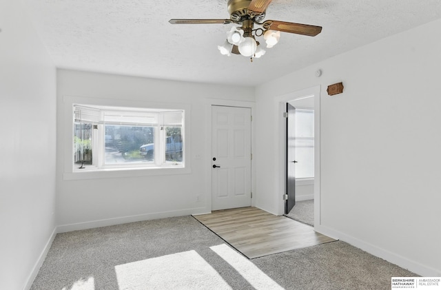 2544 N 64th St, Omaha, NE 68104 - foyer entrance featuring healthy amount of natural light, light carpet, baseboards, a ceiling fan, and a textured ceiling