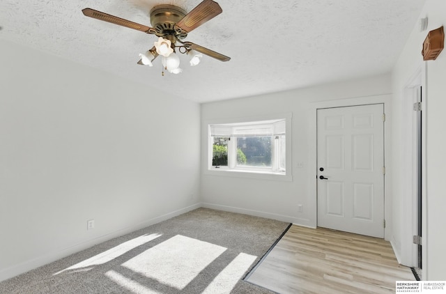2544 N 64th St, Omaha, NE 68104 - entrance foyer with ceiling fan, baseboards, a textured ceiling, and light wood-style flooring