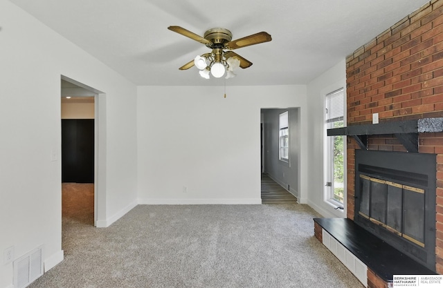 2544 N 64th St, Omaha, NE 68104 - unfurnished living room with carpet flooring, ceiling fan, a fireplace, and baseboards