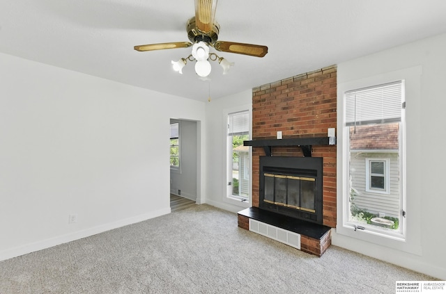 2544 N 64th St, Omaha, NE 68104 - unfurnished living room featuring carpet flooring, ceiling fan, baseboards, and a brick fireplace