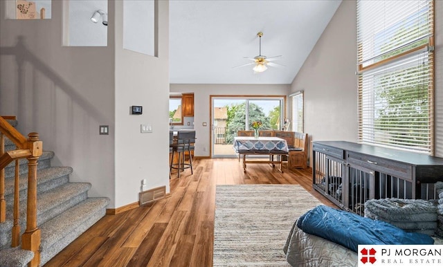 6718 Aspen St, La Vista, NE 68128 - living area featuring ceiling fan, wood finished floors, high vaulted ceiling, stairway, and baseboards