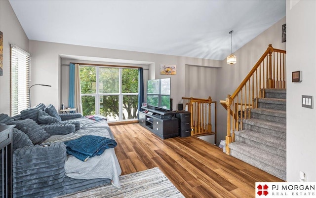 6718 Aspen St, La Vista, NE 68128 - living area with wood finished floors, healthy amount of natural light, and stairs