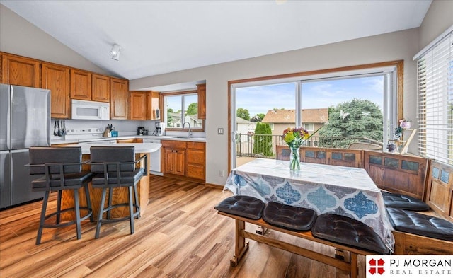 6718 Aspen St, La Vista, NE 68128 - kitchen with white appliances, light countertops, a sink, light wood finished floors, and brown cabinetry