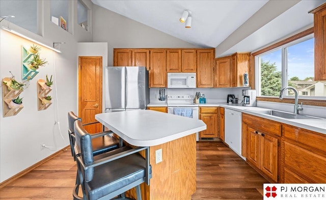 6718 Aspen St, La Vista, NE 68128 - kitchen with white appliances, a sink, light countertops, dark wood-style floors, and high vaulted ceiling