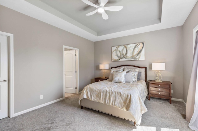 15301 Kansas Ave, Omaha, NE 68116 - bedroom with light colored carpet, a tray ceiling, baseboards, and ceiling fan