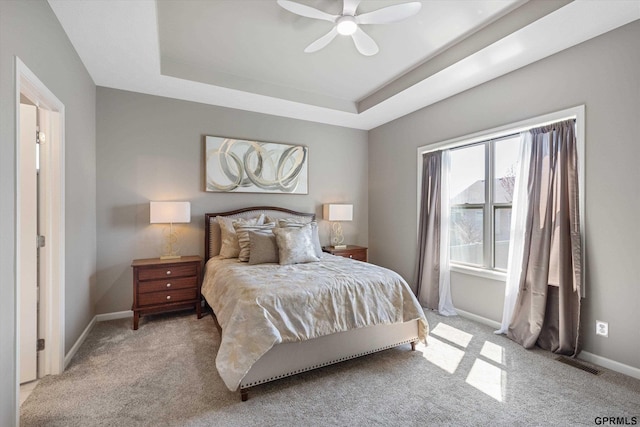 15301 Kansas Ave, Omaha, NE 68116 - bedroom featuring light colored carpet, baseboards, a raised ceiling, and a ceiling fan