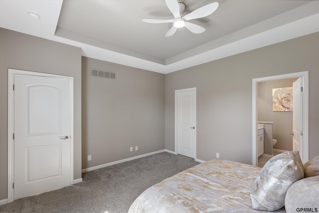 15301 Kansas Ave, Omaha, NE 68116 - carpeted bedroom with a tray ceiling, baseboards, and ensuite bathroom