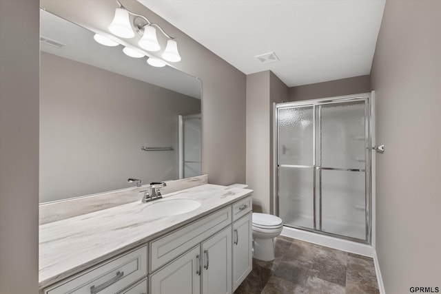 15301 Kansas Ave, Omaha, NE 68116 - bathroom with vanity, toilet, a stall shower, and stone finish flooring