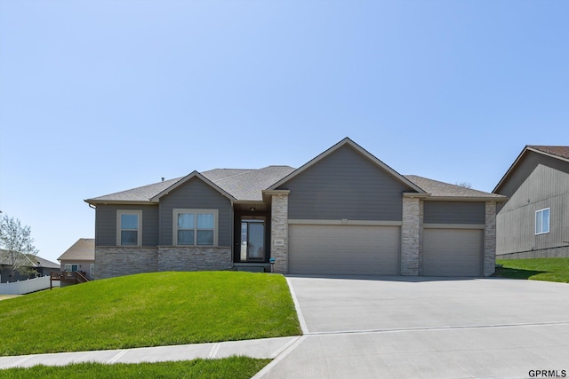 15301 Kansas Ave, Omaha, NE 68116 - view of front facade featuring concrete driveway, a garage, a front lawn, and stone siding
