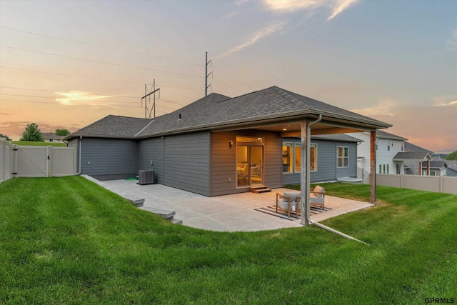 15301 Kansas Ave, Omaha, NE 68116 - back of property at dusk featuring a gate, cooling unit, a patio, and a shingled roof