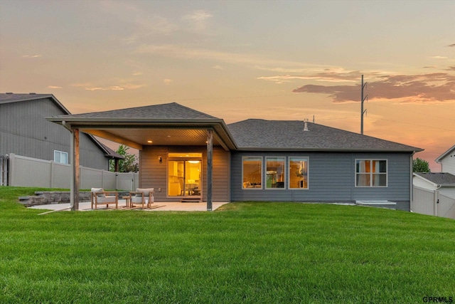 15301 Kansas Ave, Omaha, NE 68116 - back of house at dusk with a patio and roof with shingles