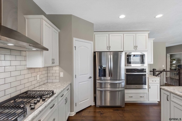 15301 Kansas Ave, Omaha, NE 68116 - kitchen with stainless steel appliances, wall chimney exhaust hood, dark wood-type flooring, backsplash, and white cabinetry