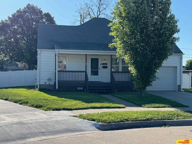 1461 E 2nd Ave, Fremont, NE 68025 - view of front of property with covered porch, an attached garage, a shingled roof, and concrete driveway