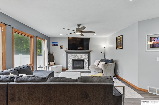 4414 S 174th St, Omaha, NE 68135 - living room featuring wood finished floors, a ceiling fan, a tile fireplace, baseboards, and recessed lighting