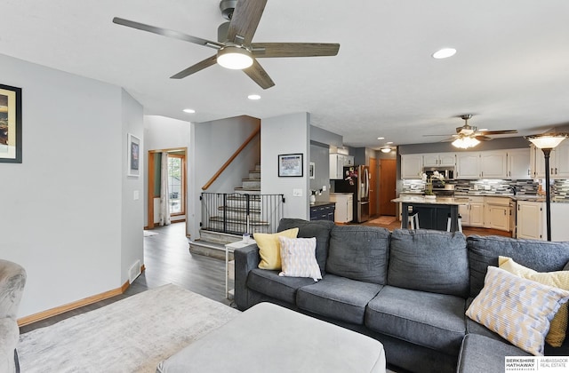 4414 S 174th St, Omaha, NE 68135 - living room with a ceiling fan, wood finished floors, stairs, recessed lighting, and baseboards