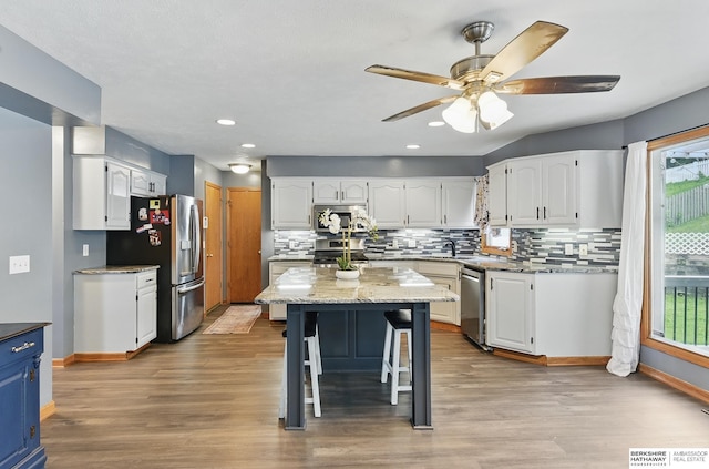 4414 S 174th St, Omaha, NE 68135 - kitchen with stainless steel appliances, white cabinetry, decorative backsplash, baseboards, and recessed lighting