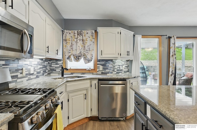 4414 S 174th St, Omaha, NE 68135 - kitchen featuring appliances with stainless steel finishes, a sink, backsplash, and light stone counters