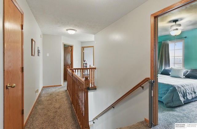4414 S 174th St, Omaha, NE 68135 - hallway featuring light carpet, an upstairs landing, baseboards, and a textured ceiling