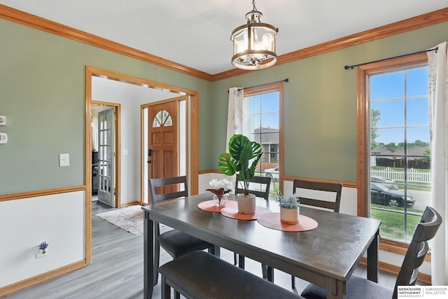 4414 S 174th St, Omaha, NE 68135 - dining space featuring ornamental molding, light wood-type flooring, a chandelier, and baseboards