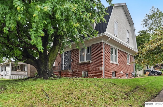 6920 N 30th St, Omaha, NE 68112 - view of property exterior with a yard and brick siding