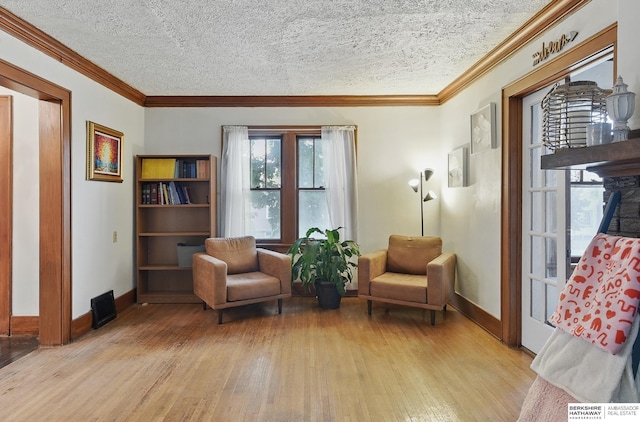 6920 N 30th St, Omaha, NE 68112 - living area featuring light wood-style flooring, healthy amount of natural light, baseboards, ornamental molding, and a textured ceiling