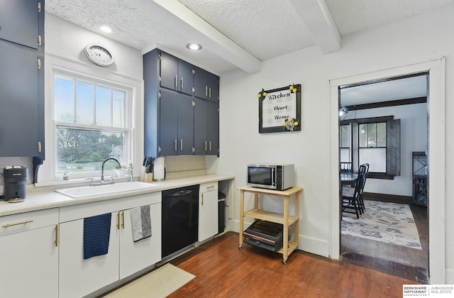 6920 N 30th St, Omaha, NE 68112 - kitchen with a sink, dishwasher, stainless steel microwave, dark wood finished floors, and light countertops