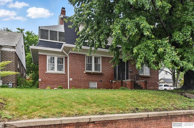 6920 N 30th St, Omaha, NE 68112 - view of front of property featuring a front lawn, brick siding, crawl space, and a chimney