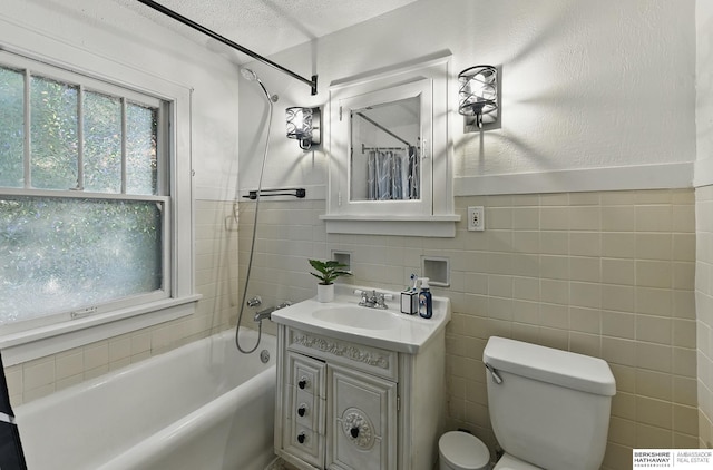 6920 N 30th St, Omaha, NE 68112 - bathroom featuring vanity, toilet, plenty of natural light, shower / bath combo with shower curtain, and tile walls