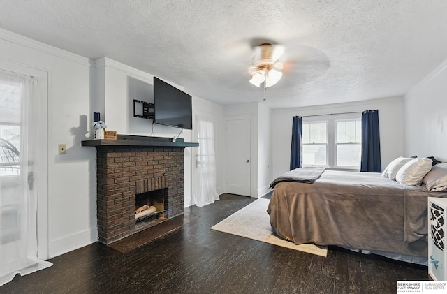 6920 N 30th St, Omaha, NE 68112 - bedroom featuring a textured ceiling, wood finished floors, a fireplace, crown molding, and a ceiling fan