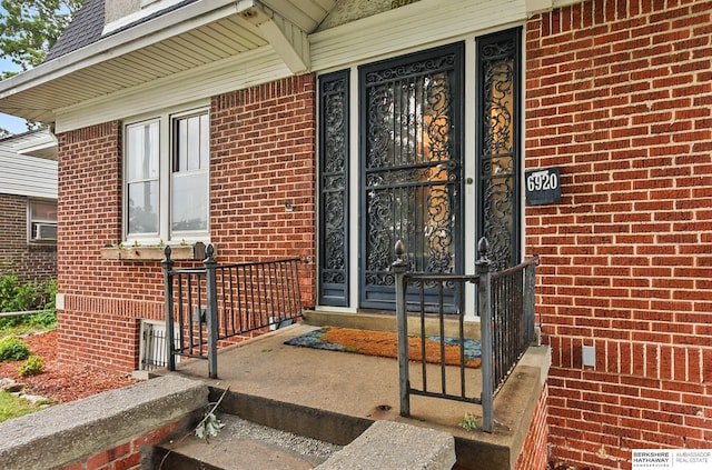 6920 N 30th St, Omaha, NE 68112 - view of exterior entry featuring brick siding and a porch