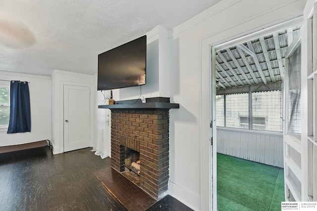 6920 N 30th St, Omaha, NE 68112 - unfurnished living room with a brick fireplace, wood finished floors, and a textured ceiling