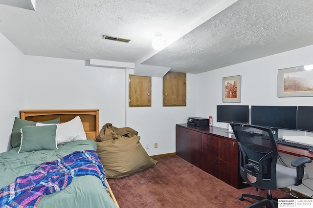 6920 N 30th St, Omaha, NE 68112 - bedroom with a textured ceiling, a desk, dark carpet, and baseboards