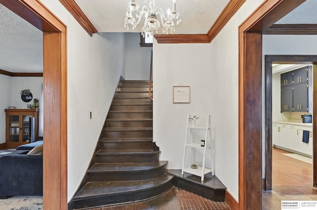 6920 N 30th St, Omaha, NE 68112 - stairway featuring a textured ceiling, crown molding, a chandelier, baseboards, and wood finished floors