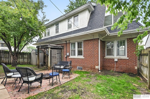 6920 N 30th St, Omaha, NE 68112 - rear view of house featuring a fenced backyard, a patio, brick siding, and roof with shingles