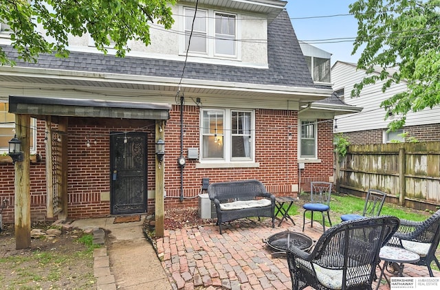 6920 N 30th St, Omaha, NE 68112 - back of property with an outdoor fire pit, brick siding, a patio, and roof with shingles