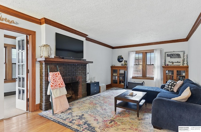6920 N 30th St, Omaha, NE 68112 - living area featuring wood finished floors, crown molding, a textured ceiling, and a fireplace