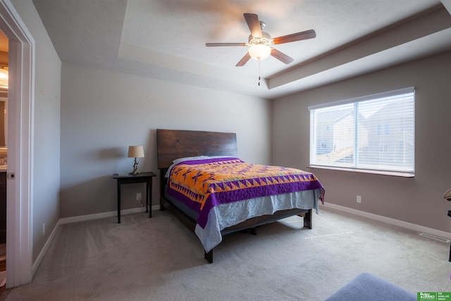 6311 N 169th St, Omaha, NE 68116 - carpeted bedroom featuring a tray ceiling, baseboards, and ceiling fan