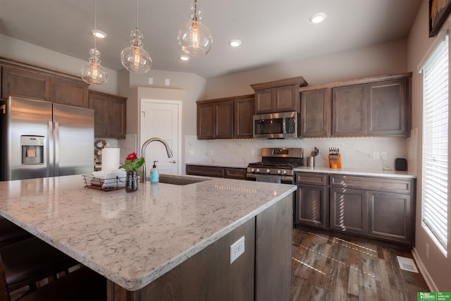 6311 N 169th St, Omaha, NE 68116 - kitchen featuring appliances with stainless steel finishes, a sink, backsplash, light stone counters, and recessed lighting